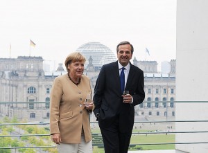 Řecký premiér Samaros s německou kancléřkou Merkelovou. Autorem snímku je Matanya.